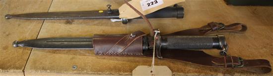 Swedish bayonets, one with leather holder(-)